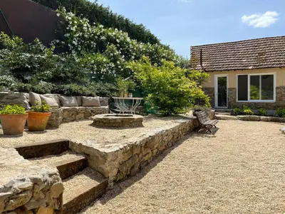 a garden with a stone retaining wall and stairs at seixurra 31 in A Coruña