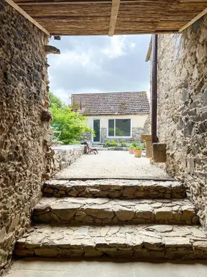 an external view of a stone house with a stone wall at seixurra 31 in A Coruña
