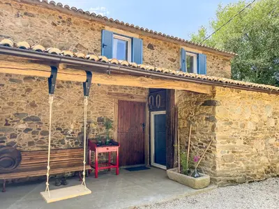 a stone house with a bench in front of it at seixurra 31 in A Coruña