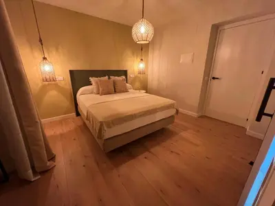 a bedroom with a bed with two lamps and a table at Casal de pelaio in Barreiros