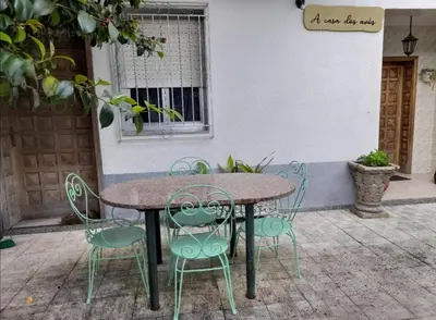 a table and chairs sitting outside of a building at A CASA DOS AVÓS in Celanova