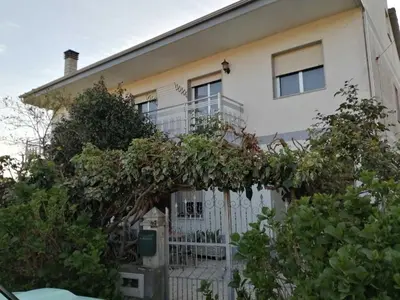 a white house with a white fence and trees at A CASA DOS AVÓS in Celanova