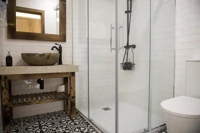 a bathroom with a glass shower and a sink at PENSION SOBRADO in Porta