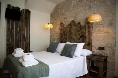 a bedroom with a bed with towels on it at PENSION SOBRADO in Porta