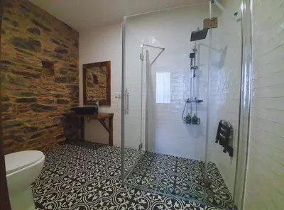 a bathroom with a shower with a glass door at PENSION SOBRADO in Porta