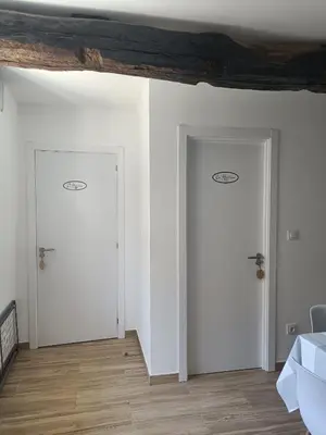 two doors in a room with white walls and wooden floors at CASA A CALLE in O Pino