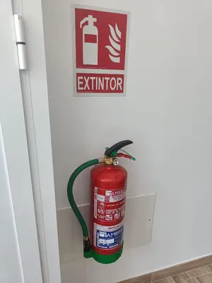 a fire hydrant in a wall with a fire extinguisher at CASA A CALLE in O Pino