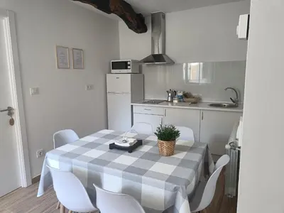 a kitchen with a table and chairs in a room at CASA A CALLE in O Pino