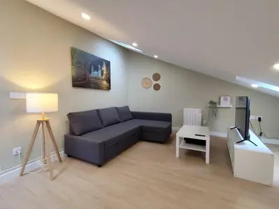 a living room with a couch and a tv at Atico Porta de Santiago - Junto Catedral - VUT-LU-02906 in Lugo