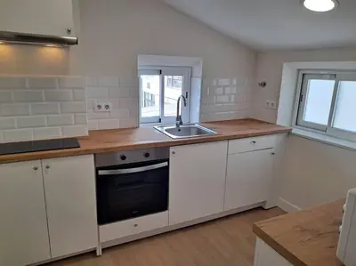 a kitchen with white cabinets and a sink at Atico Porta de Santiago - Junto Catedral - VUT-LU-02906 in Lugo