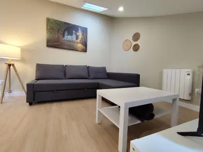 a living room with a couch and a table at Atico Porta de Santiago - Junto Catedral - VUT-LU-02906 in Lugo