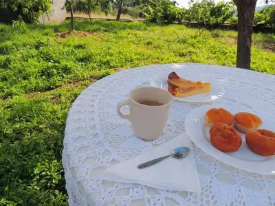 a table with a cup of coffee and a plate of food at Casa de Ribeira Sacra in Pantón