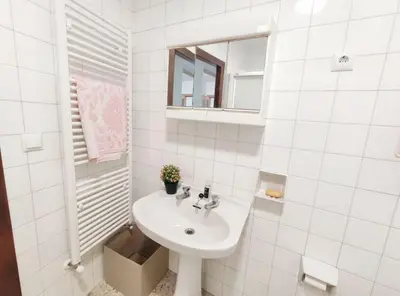 a white bathroom with a sink and a mirror at Casa de Ribeira Sacra in Pantón