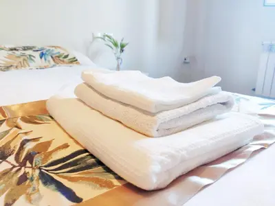 a pile of towels sitting on a bed at Casa de Ribeira Sacra in Pantón