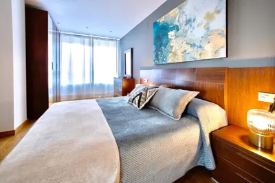 a bedroom with a large bed and a painting on the wall at Muralla & Views by Lugo Collection in Lugo