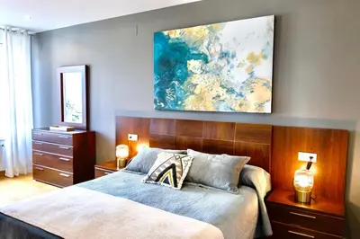 a bedroom with a bed and a painting on the wall at Muralla & Views by Lugo Collection in Lugo