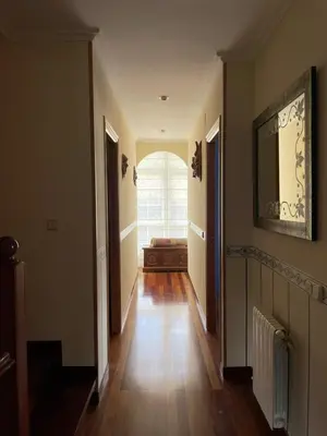 a hallway of a home with a window and a wooden floor at Cabo de Veiga in Trabada
