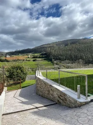 a balcony with a fence and a view of a field at Cabo de Veiga in Trabada