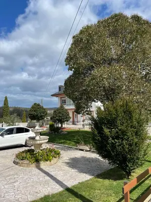 a white car parked in front of a house at Cabo de Veiga in Trabada