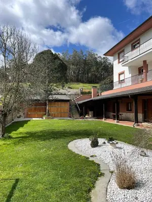 a yard with a building and a grass field at Cabo de Veiga in Trabada