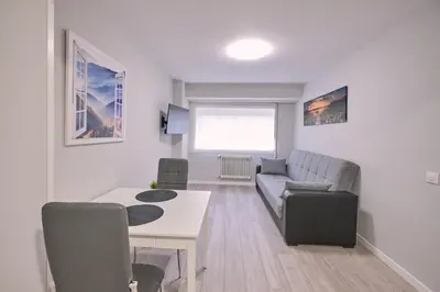 a living room with a couch and a table at La Casa de Julia Apartamento nuevo y céntrico in Santiago de Compostela