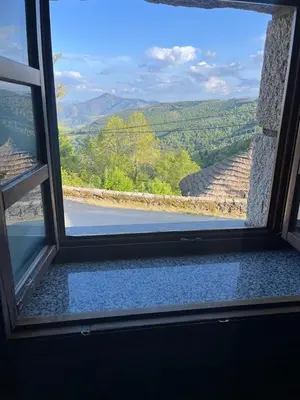 a window with a view of a mountain view at Habitaciones Frade in O Cebreiro