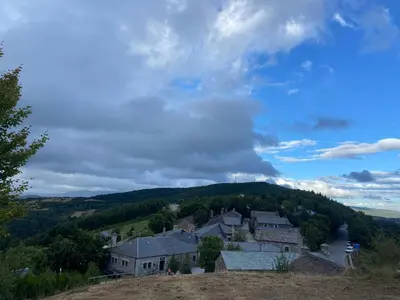 a village on top of a hill with houses at Habitaciones Frade in O Cebreiro