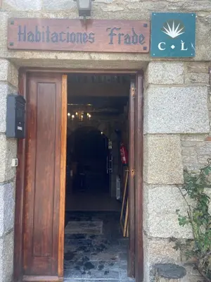 a door to a building with a sign above it at Habitaciones Frade in O Cebreiro