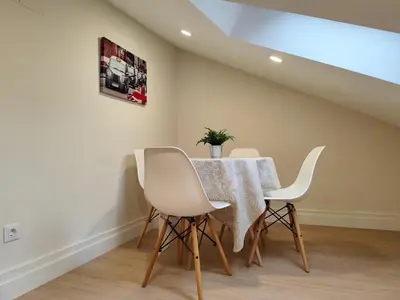 a dining room with a table and white chairs at Catedral y Muralla a 50 metros - VUT-LU-02907 in Lugo