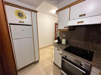 a kitchen with a sunflower sticker on the wall at Porta da Vila by Oktheway in Puentedeume