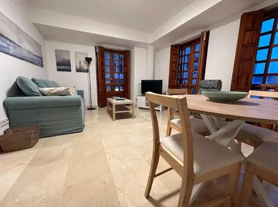 a living room with a table and a couch at Porta da Vila by Oktheway in Puentedeume