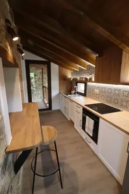 a kitchen with a counter and a table in it at Casa Fente in Taboada