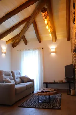 a living room with a couch and a window at Casa Fente in Taboada