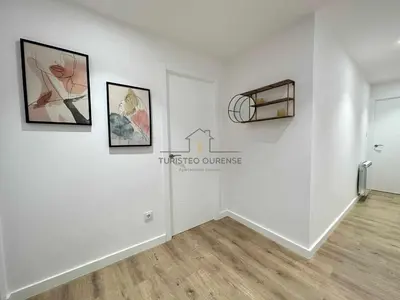 a white room with paintings on the wall at A Morada das Mimosas in Ourense