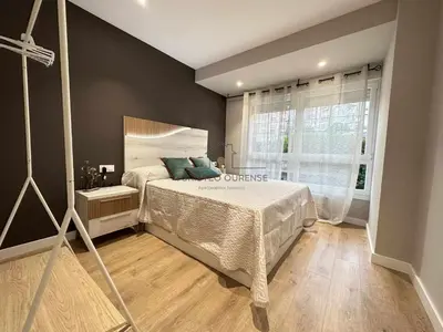 a bedroom with a large bed and a window at A Morada das Mimosas in Ourense