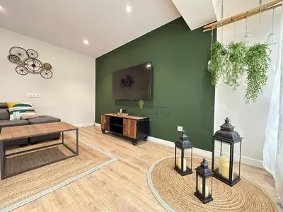 a living room with a couch and a table at A Morada das Mimosas in Ourense
