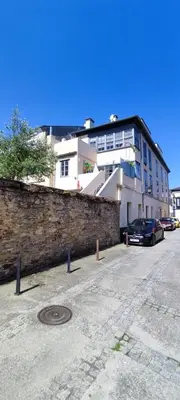a car parked in a parking lot in front of a building at HOSTEL NAMOR in Ribadeo