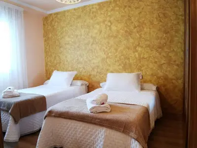 a room with two beds with towels on them at A DE NENO in Melide