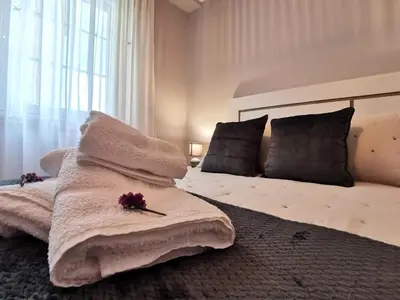 a bedroom with a large bed with flowers on it at A DE NENO in Melide