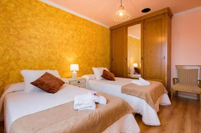 a hotel room with two beds with towels on them at A DE NENO in Melide