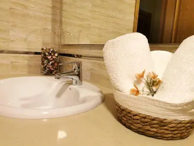 a bathroom with a sink and a basket with towels at A DE NENO in Melide