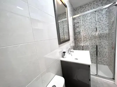 a bathroom with a toilet and a sink and a shower at EL NORTE in Viveiro