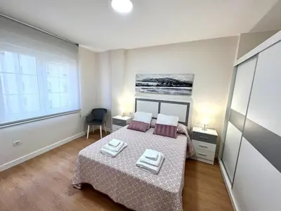 a bedroom with a bed with two pillows on it at EL NORTE in Viveiro