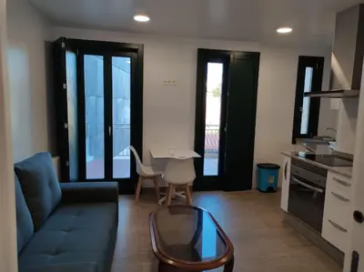 a living room with a couch and a table at Apartamento Salvadas in Santiago de Compostela