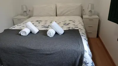 a bedroom with a bed with two pillows on it at Apartamento Salvadas in Santiago de Compostela