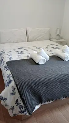 a bed with two pillows on top of it at Apartamento Salvadas in Santiago de Compostela
