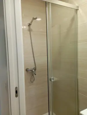 a shower stall with a glass door in a bathroom at Apartamento Salvadas in Santiago de Compostela
