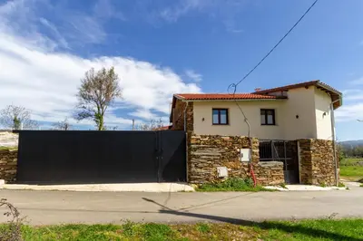 a house with a black gate in front of a house at Casa Añolo in Sober