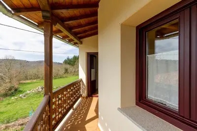 a balcony of a house with a large window at Casa Añolo in Sober