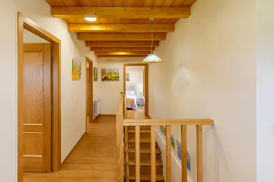 a hallway with a wooden ceiling and a staircase at Casa Añolo in Sober